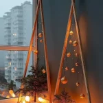 Modern geometric Christmas tree decor illuminated with fairy lights