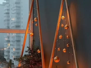 Modern geometric Christmas tree decor illuminated with fairy lights