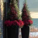 Beautiful DIY Christmas planters on a front porch, adorned with festive decorations.
