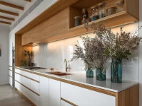 Sage green and wood kitchen design featuring elegant cabinetry and modern decor.