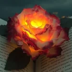 DIY flower tea light candle with floral decorations in a cozy setting.